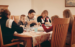 The Coppola family sitting at the dinner table.