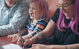 Mom and Daughter Smiling at Desk