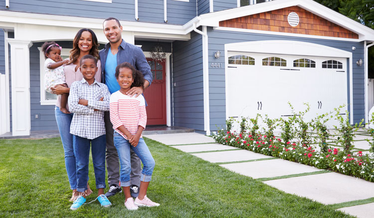 A family standing in front of their house