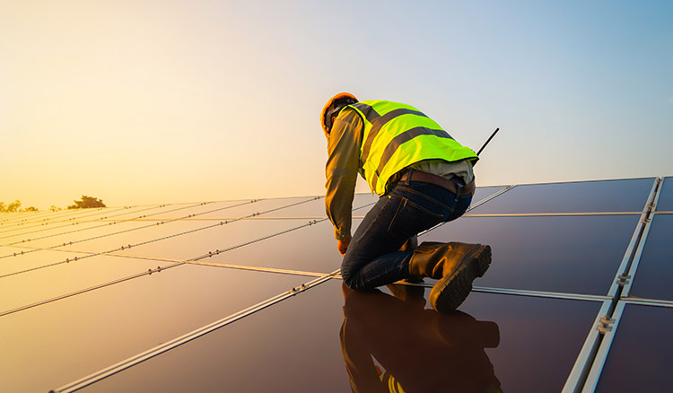 man working on solar power panels