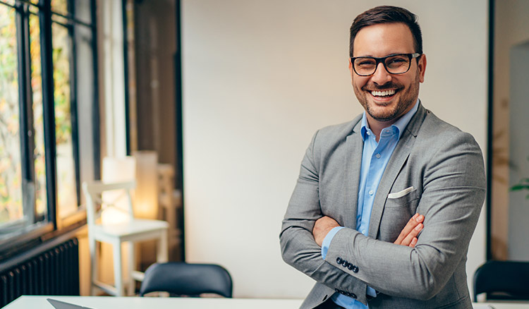 Caucasian Business Man Sitting On Desk