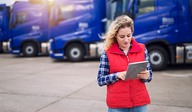 Female Worker Outside Near Semi Trucks