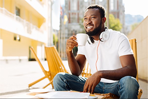 african american man on balcony with cup